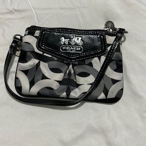 Black, gray and white coach wristlet